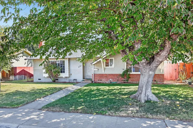 a front view of house with yard and green space