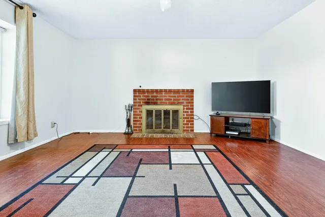 a living room with a flat screen tv and a fireplace