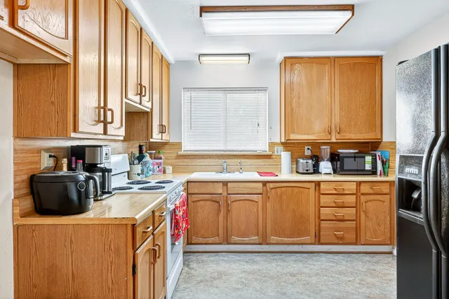 a kitchen with a stove a sink and a refrigerator