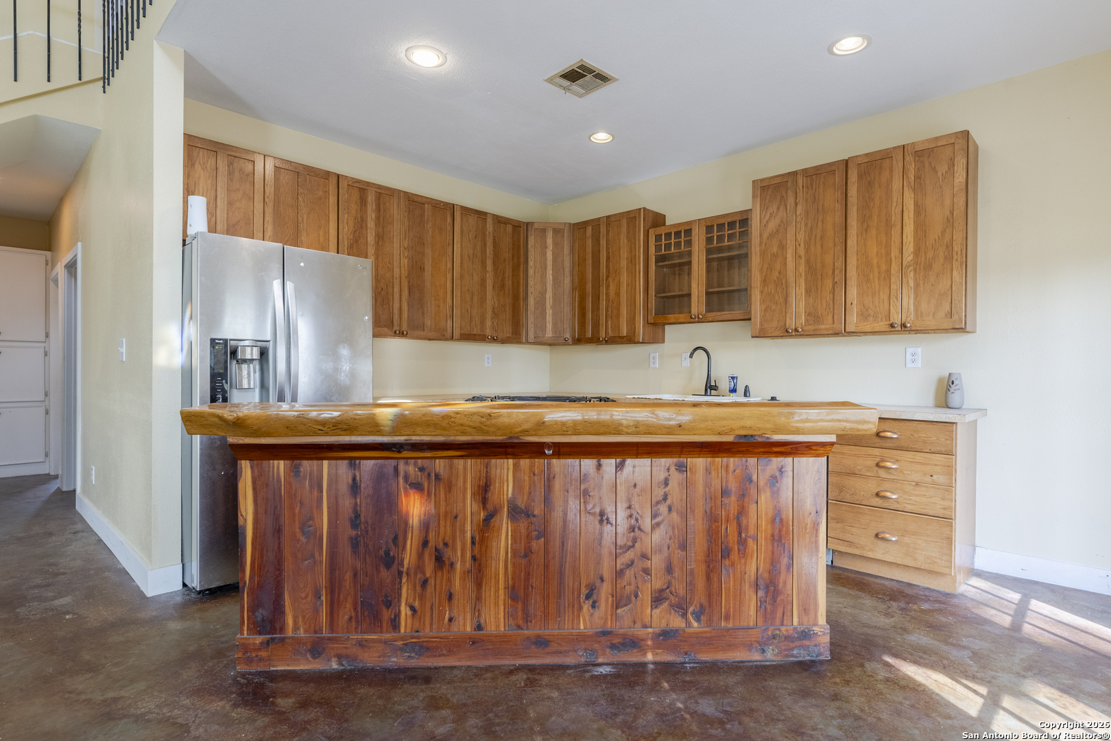 4419 State Highway 71 Columbus, TX 78934 - Photo 26 of 49 a kitchen with kitchen island granite countertop a sink window and refrigerator