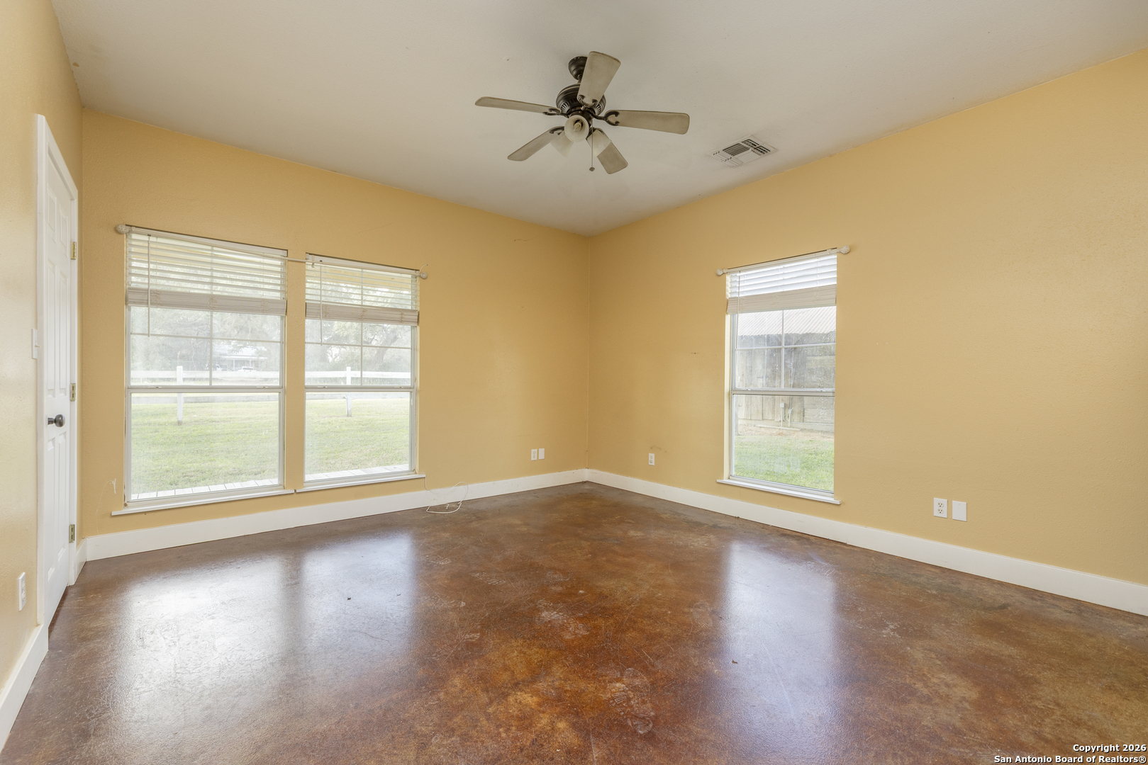 4419 State Highway 71 Columbus, TX 78934 - Photo 8 of 49 an empty room with wooden floor and windows