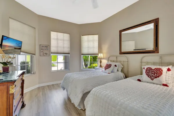 a bedroom with two beds and a window