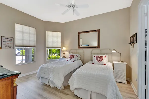 a bedroom with two beds and a window