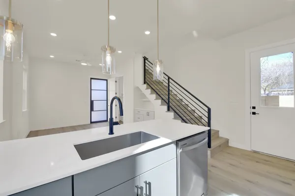 a kitchen with a sink and a refrigerator