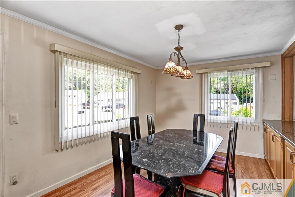 17 Brandeis Road Old Bridge, NJ 08859 - Photo 15 of 30 a dining room with furniture a chandelier and wooden floor