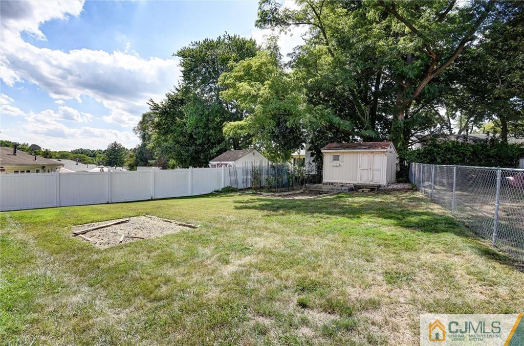 17 Brandeis Road Old Bridge, NJ 08859 - Photo 30 of 30 a backyard of a house with trees and retail fence