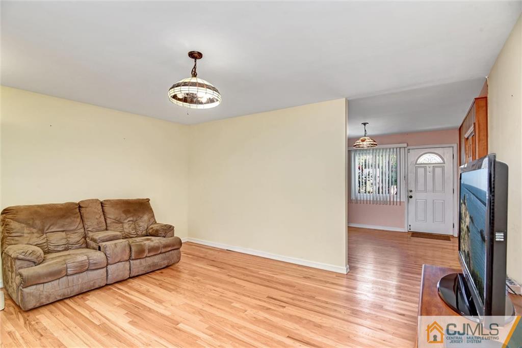 17 Brandeis Road Old Bridge, NJ 08859 - Photo 7 of 30 a living room with furniture ceiling fan and a wooden floor