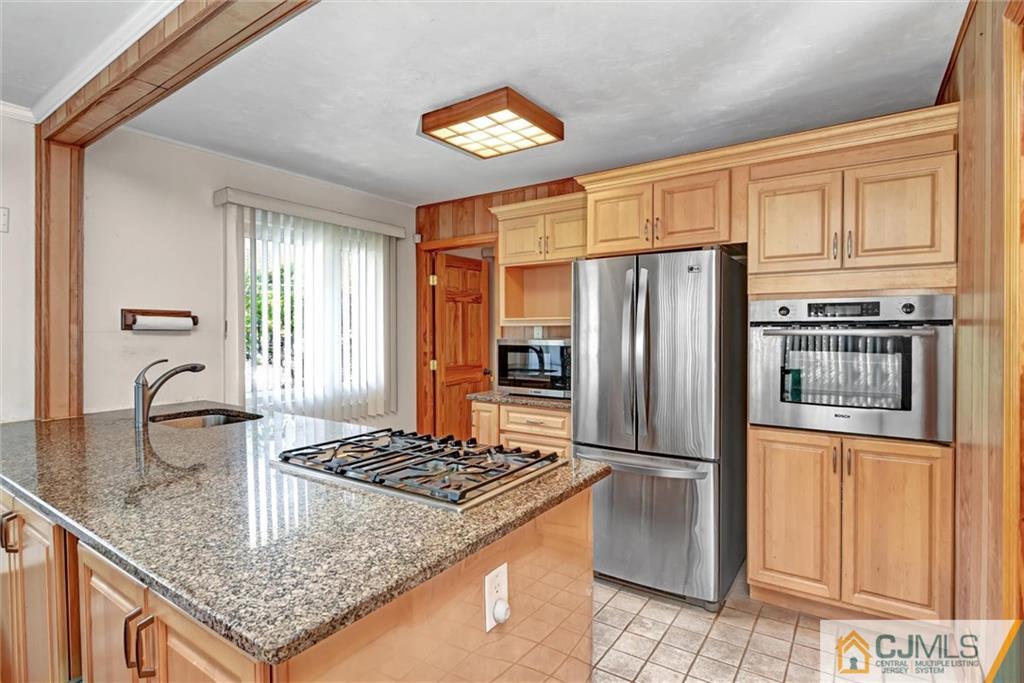 17 Brandeis Road Old Bridge, NJ 08859 - Photo 9 of 30 a kitchen with stainless steel appliances granite countertop a refrigerator a stove and a sink