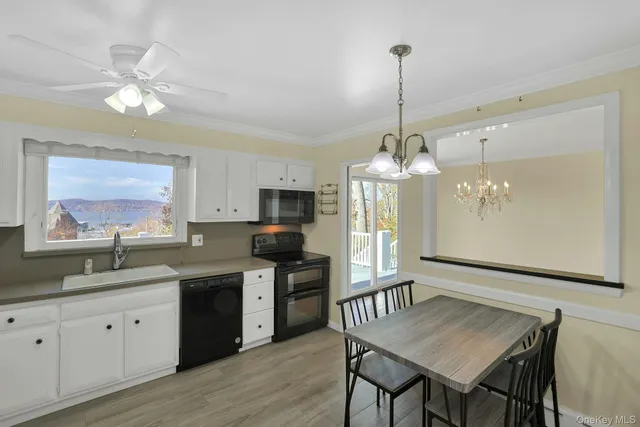 a kitchen with stainless steel appliances granite countertop a sink dishwasher a dining table and chairs with wooden floor