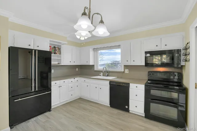 a kitchen with a refrigerator and a stove top oven