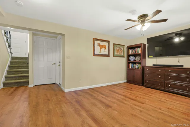 a view of a room with a piano and wooden floor