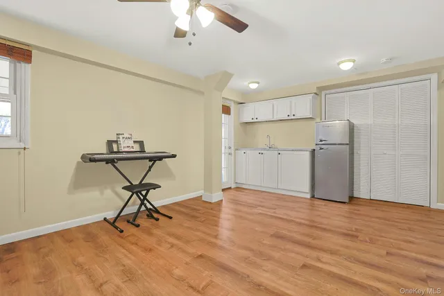 a view of a workspace with furniture and a window