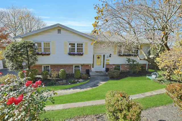 a front view of a house with garden