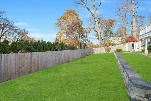 a view of house with a yard