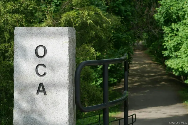 a backyard of a house with lots of green space and wooden fence