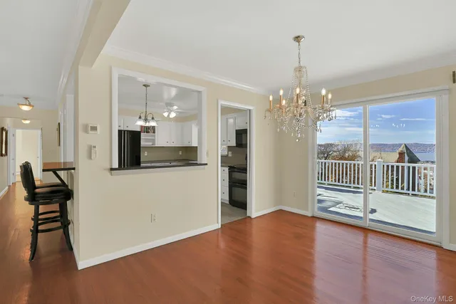 a view of a room with wooden floor and windows