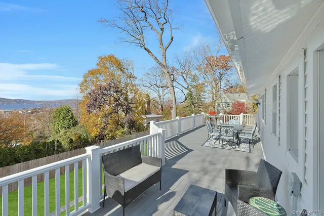 a view of balcony with wooden floor and outdoor seating