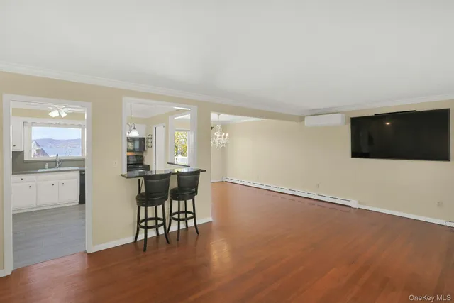 a view of a kitchen with furniture and wooden floor