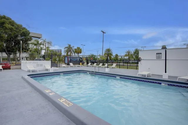 a view of swimming pool with outdoor seating and city view
