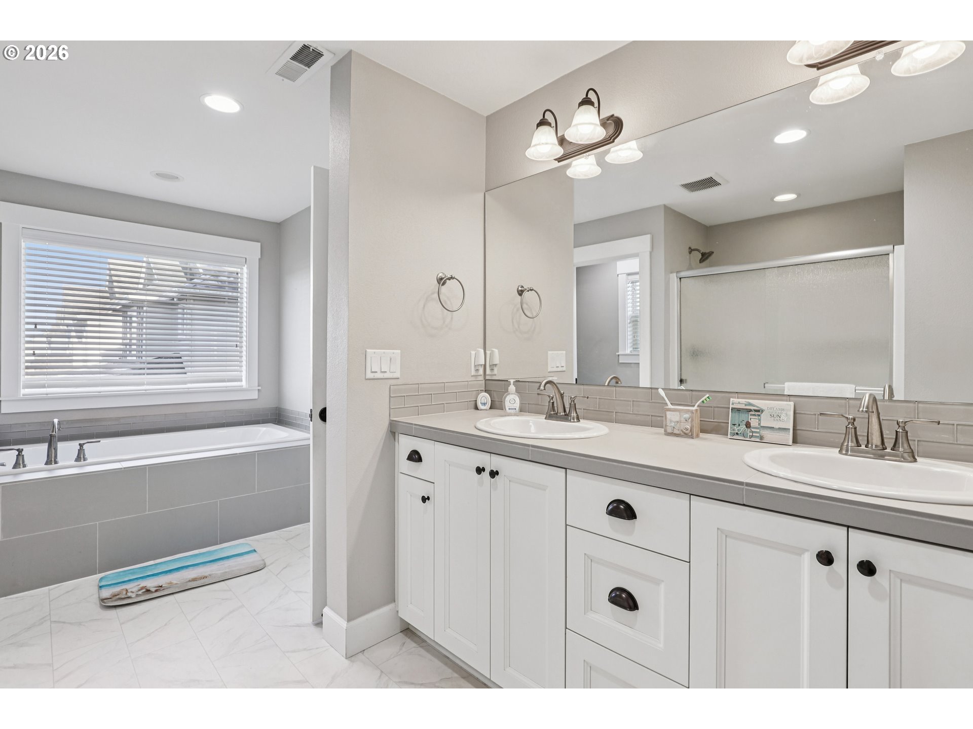 7346 South 13th Street Ridgefield, WA 98642 - Photo 27 of 38 a bathroom with a granite countertop sink mirror and bathtub