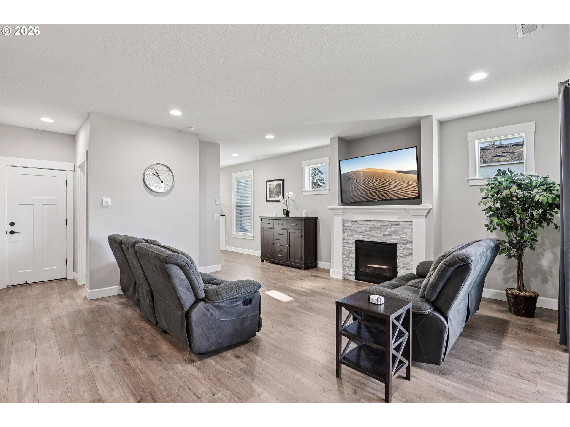 7346 South 13th Street Ridgefield, WA 98642 - Photo 6 of 38 a living room with furniture a fireplace and a potted plant