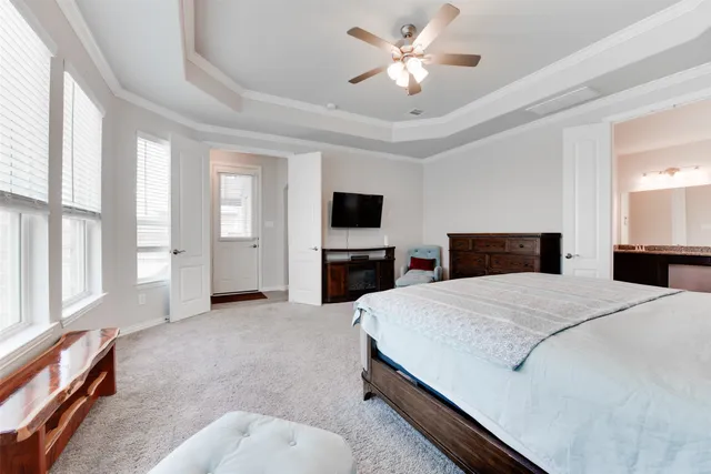 a large bedroom with a bed and a chandelier