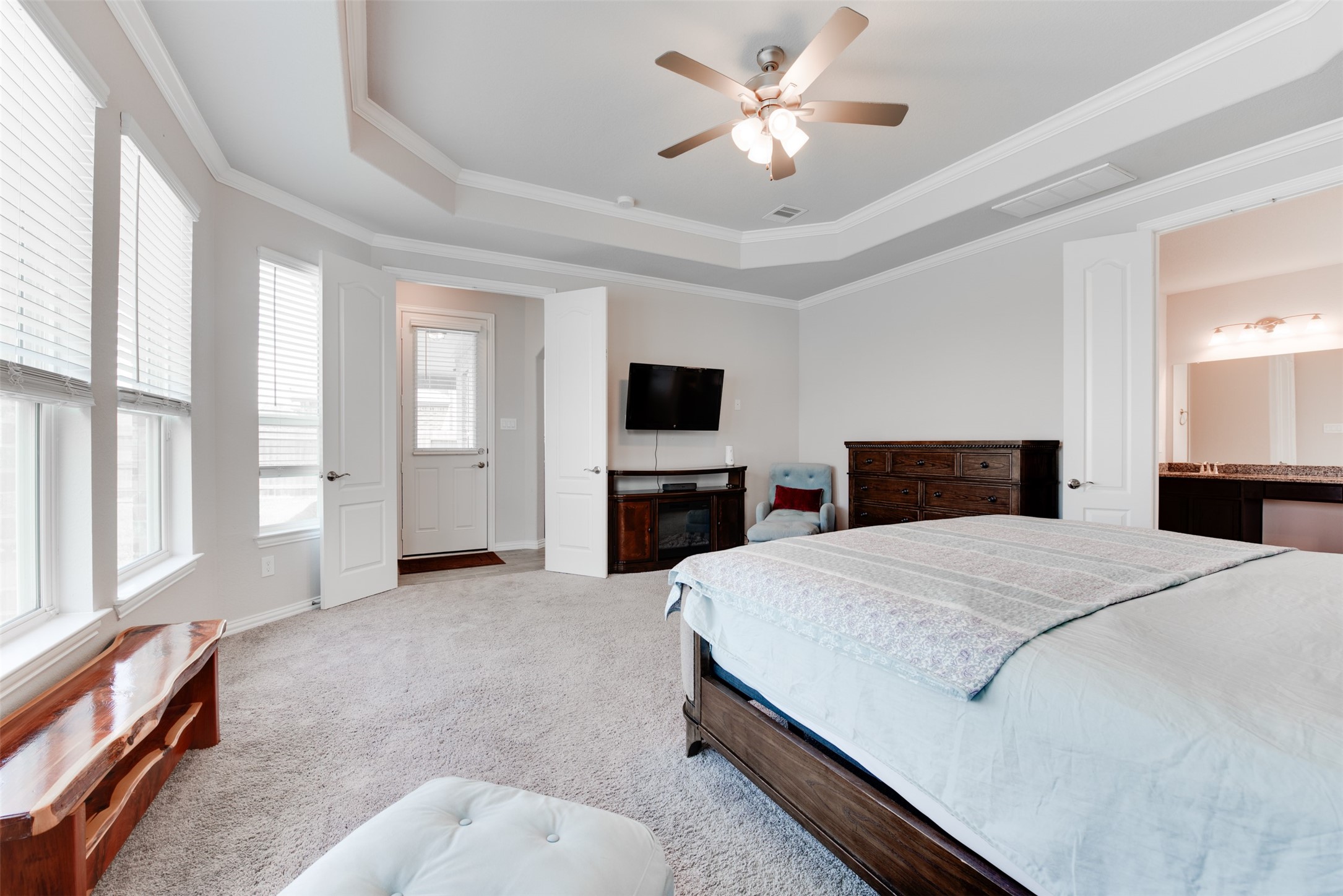 4310 Markstone Ridge Lane Rosharon, TX 77583 - Photo 18 of 40 a large bedroom with a bed and a chandelier