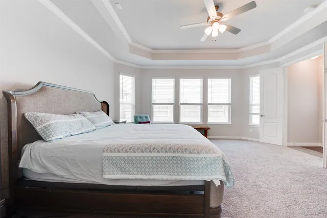 a spacious bedroom with a large bed and a large window