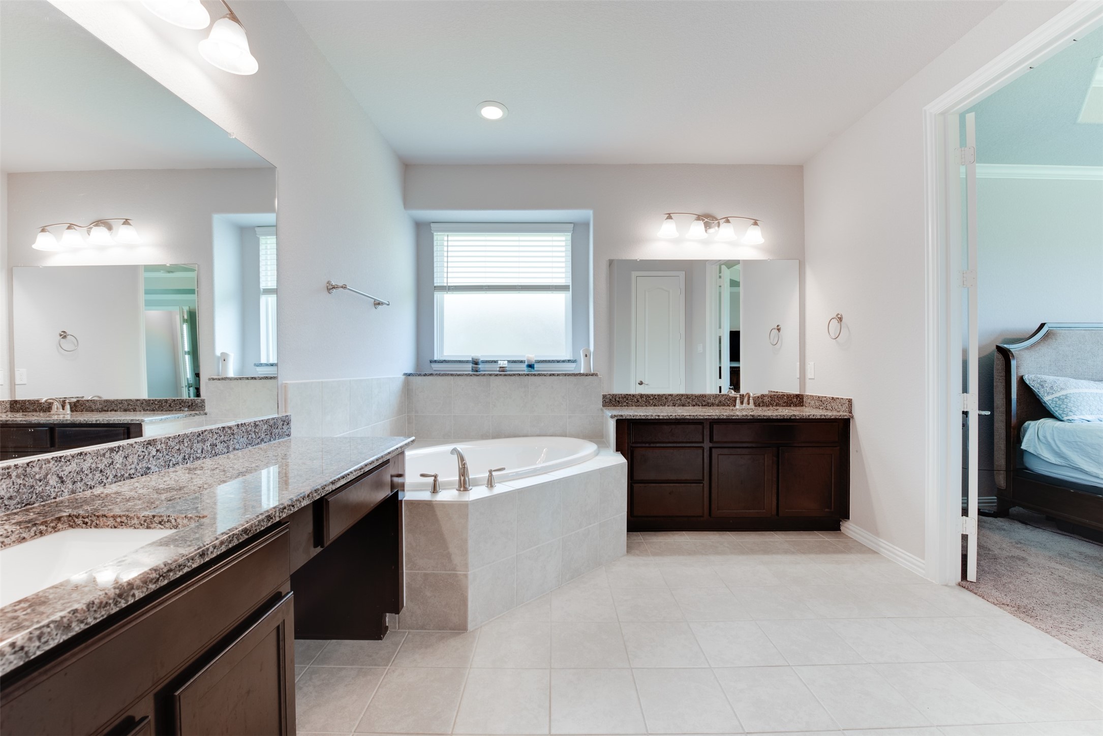 4310 Markstone Ridge Lane Rosharon, TX 77583 - Photo 21 of 40 a spacious bathroom with a granite countertop bathtub sink and mirror