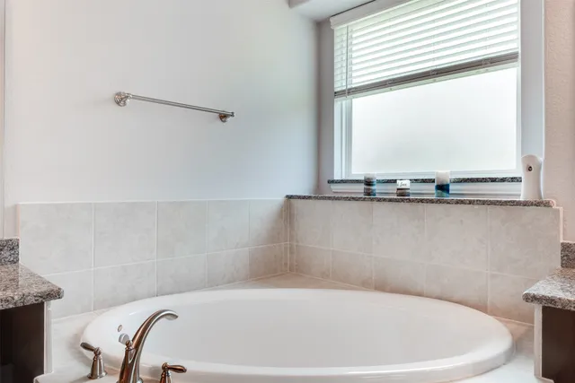 a bathroom with a bathtub and window