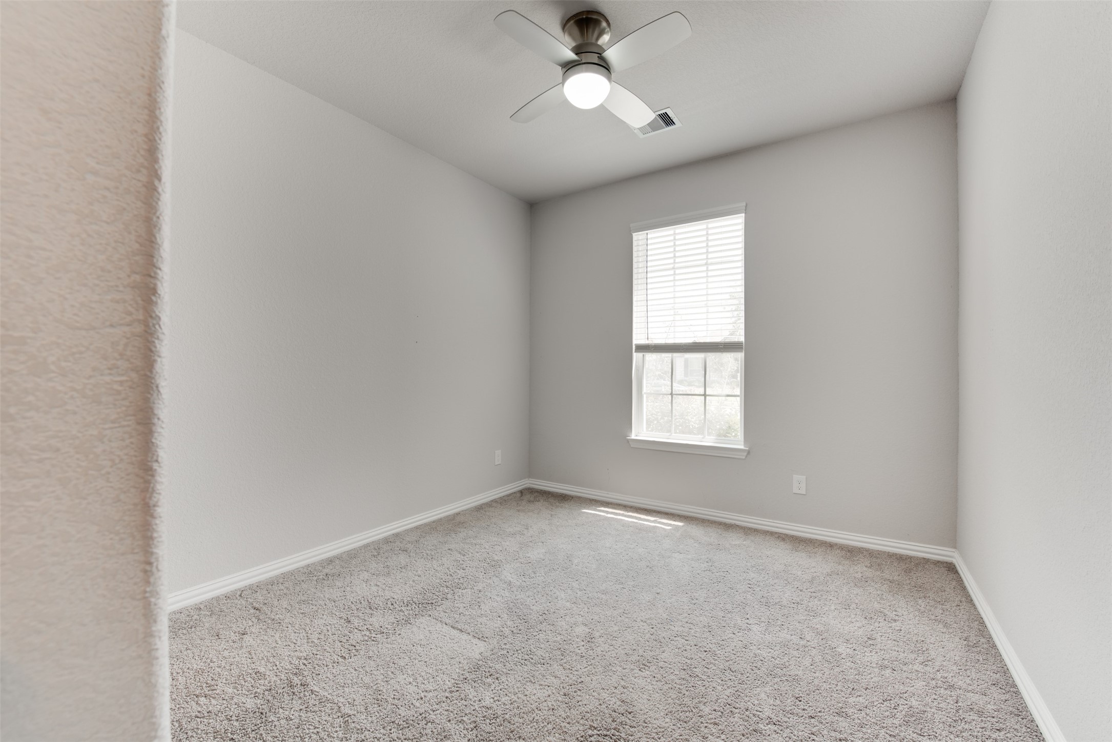 4310 Markstone Ridge Lane Rosharon, TX 77583 - Photo 25 of 40 an empty room with a window and a fan