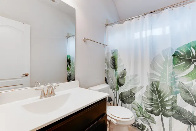 a bathroom with a sink a toilet and a mirror