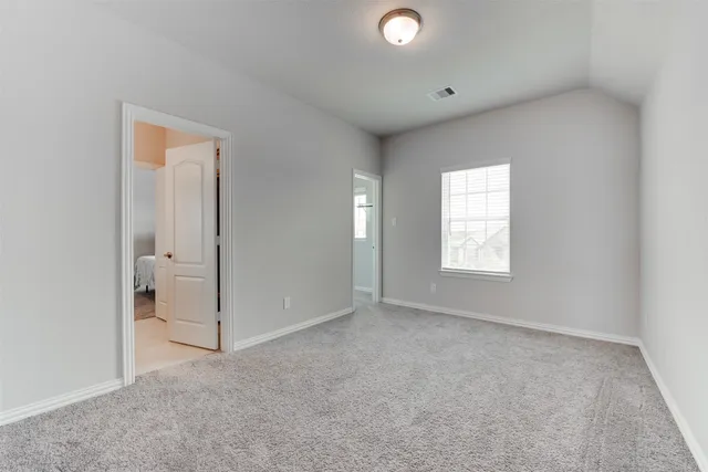 an empty room with windows and closet
