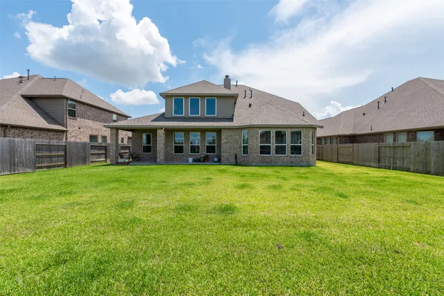 a view of a house with a backyard