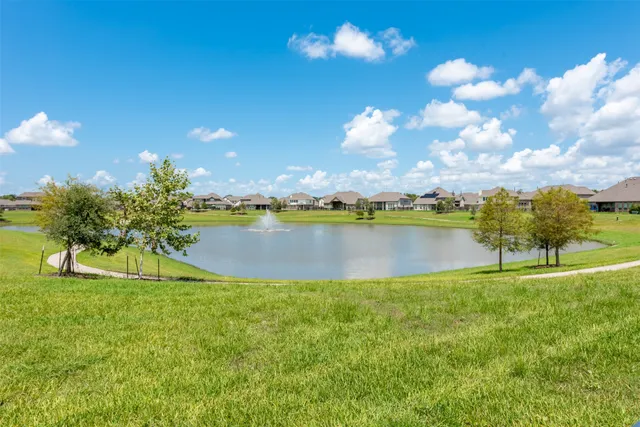 a view of a lake with houses in the back