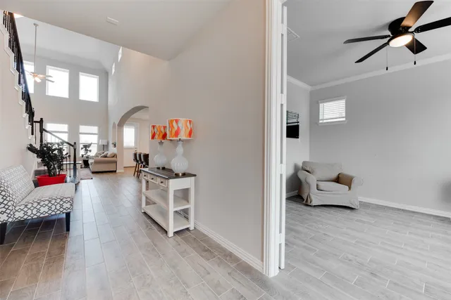 a living room with furniture and a wooden floor