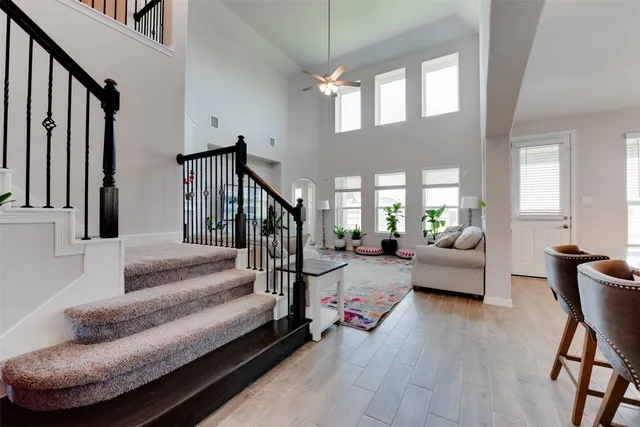 a living room with furniture and a dining table