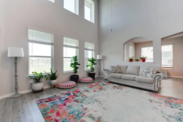 a living room with furniture potted plant and a window