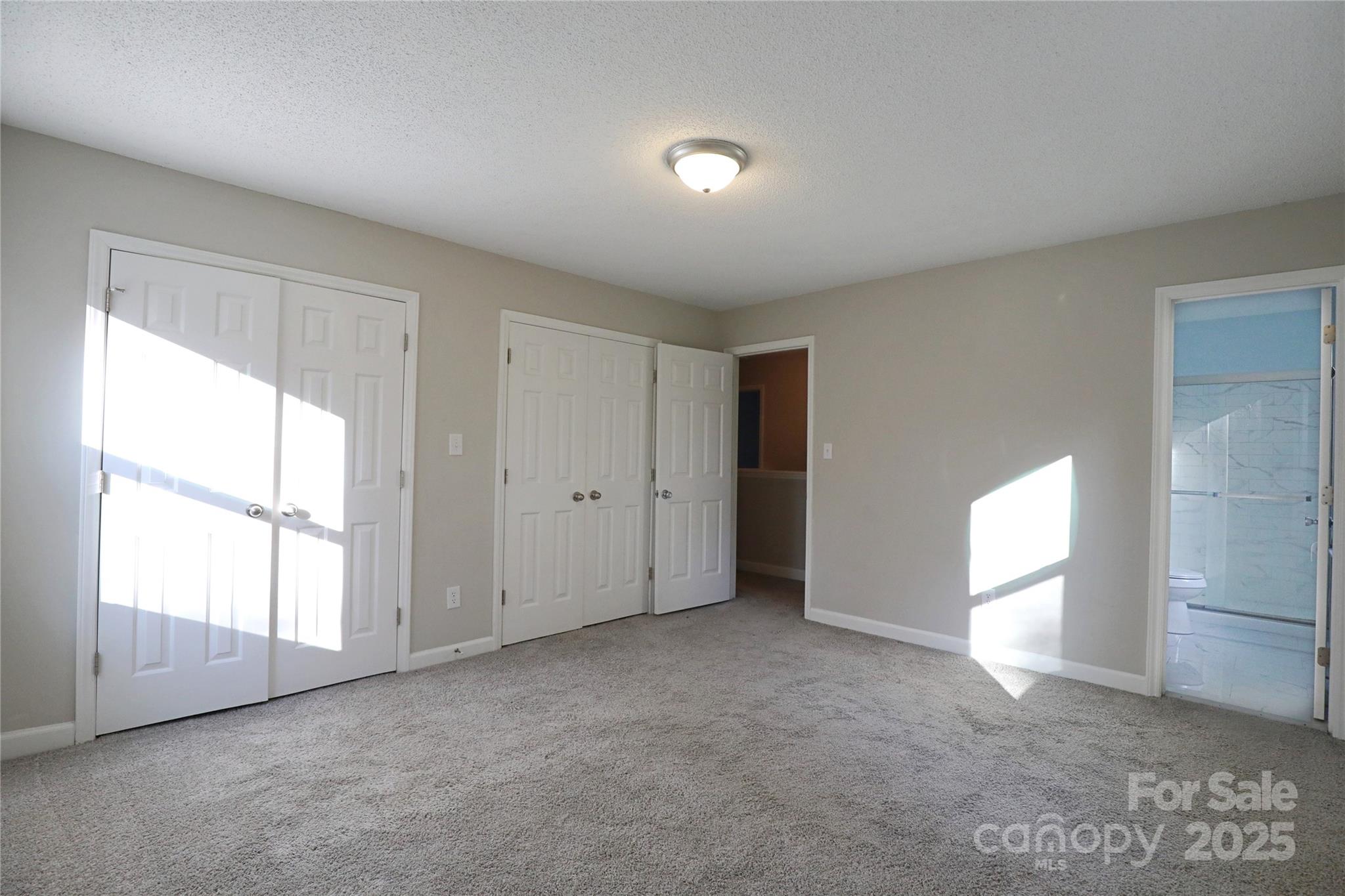 14027 Hackamore Drive Matthews, NC 28105 - Photo 15 of 29 an empty room with windows and closet