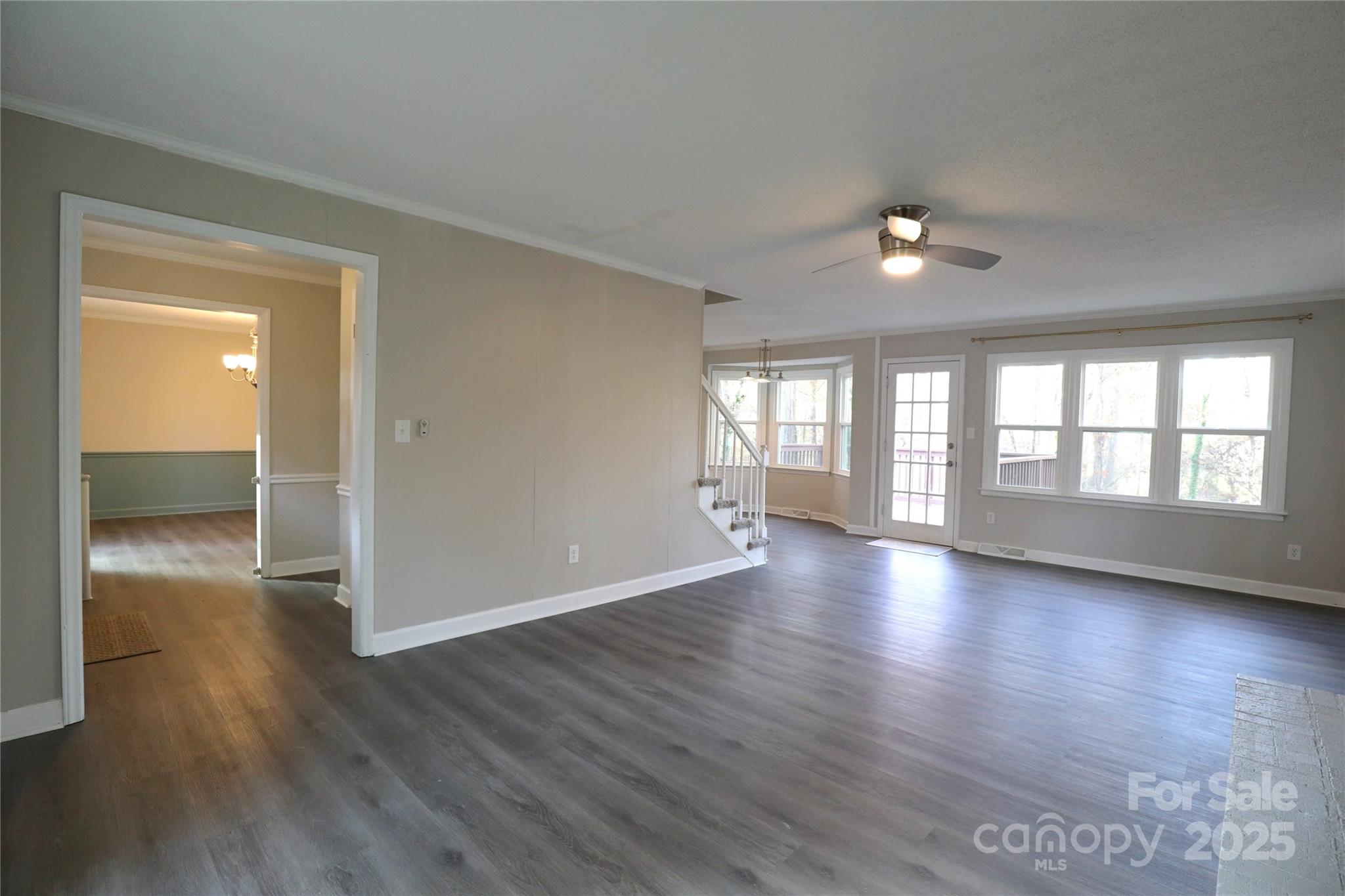 14027 Hackamore Drive Matthews, NC 28105 - Photo 3 of 29 an empty room with wooden floor and windows