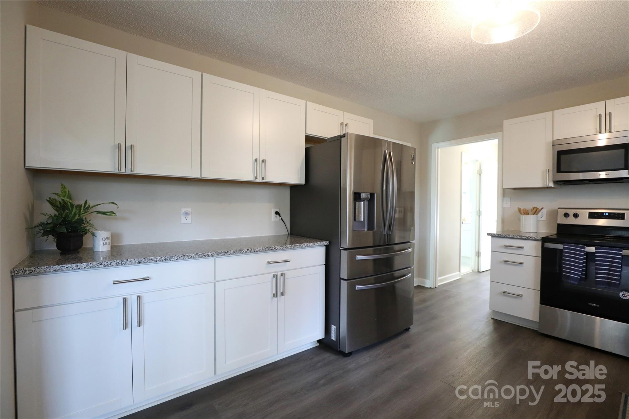 14027 Hackamore Drive Matthews, NC 28105 - Photo 7 of 29 a kitchen with stainless steel appliances white cabinets and a sink