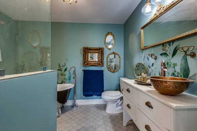 a room with a potted plant and a toilet