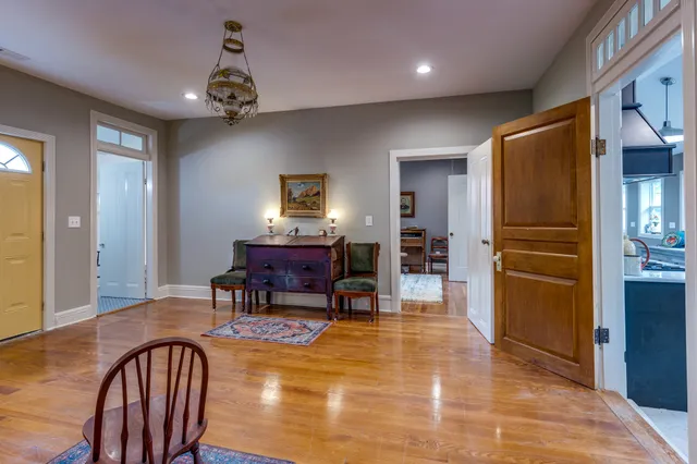 a kitchen with stainless steel appliances granite countertop a refrigerator a stove a sink dishwasher with a dining table and chairs