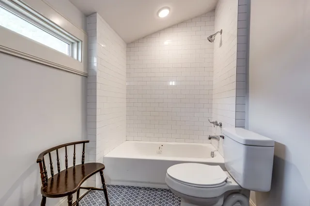 a bathroom with a toilet a sink and bathtub