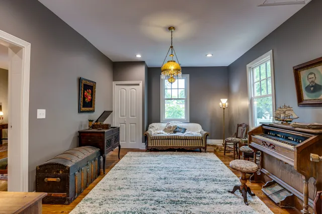 a bedroom with furniture and a window