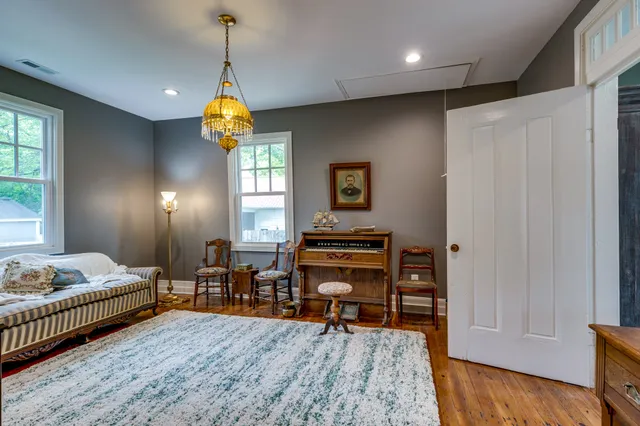 a room with furniture a rug and a window