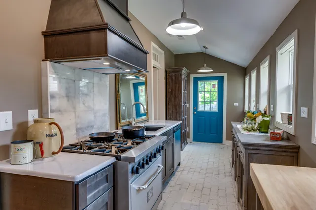 a kitchen that has a stove and a table