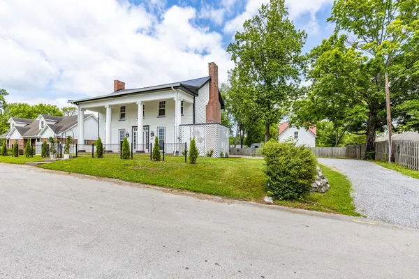 a front view of house with yard and green space