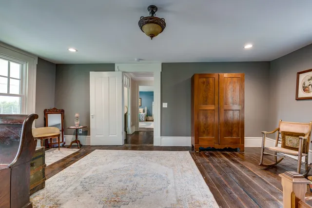 a bedroom with furniture and a window