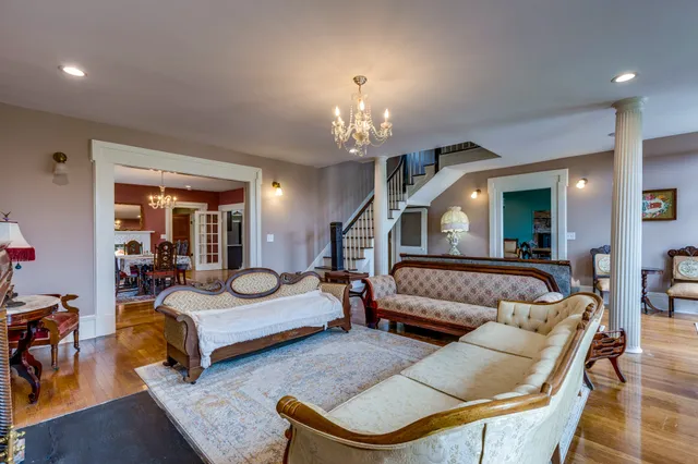 a bedroom with furniture and a chandelier